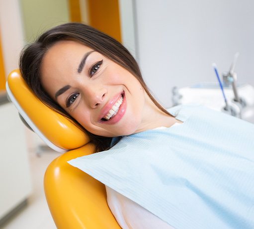 Woman smiling while relaxing in the dental treatment chair