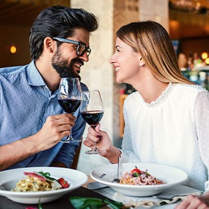 Couple smiling at each other on date in restaurant