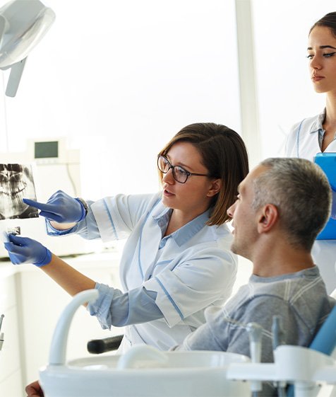 Dentist showing a patient an x ray of their teeth