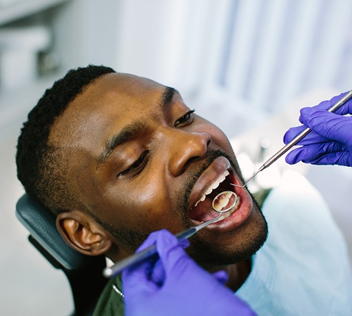 Man having dental exam completed