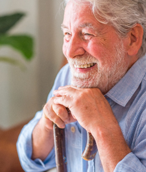 Senior man grinning with dental bridges in Medford