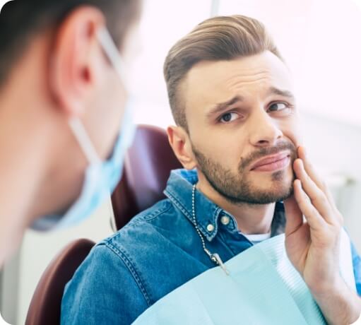 Man in pain discussing diagnosis and TMJ treatment