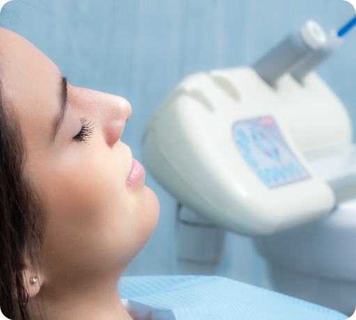 Rleaxed woman in the dental chair with her eyes closed