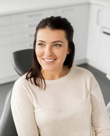 Woman in dental chair smiling