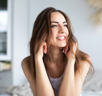 Woman with long brown hair looking off into the distance