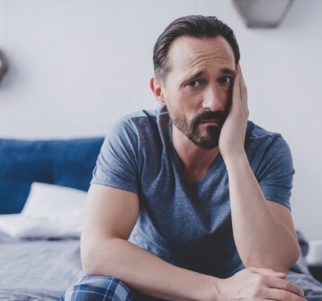 Man holding his cheek in pain