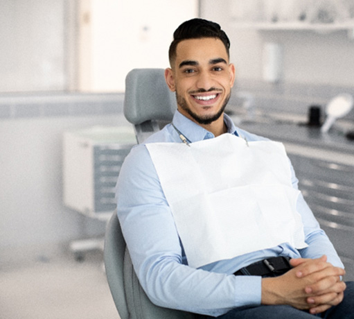 Patient smiling while sitting in treatment chair