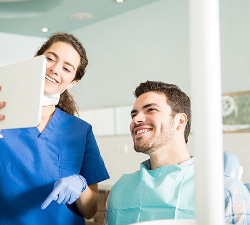 Dentist showing a patient a tablet